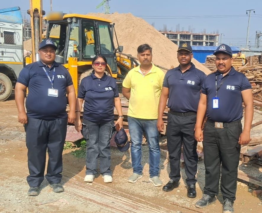 RS Enterprises staff in navy uniform at a construction site